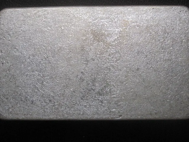 a cast silver bar (Reserve Cast Silver from Scottsdale Silver): dips, ripples, and a satin frost finish. Buying and Storing Physical Silver: Costs, Taxes, Rules
