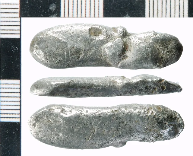 Silver possible ingot. Cast bar of oval section with rounded ends, with one flat surface suggesting it has solidified on a flat smooth surface; the opposite long side may have been lightly hammered. The form may commend an identification as a silver ingot, but, in the absence of clear hammering mark. How to document a non-destructive bullion examination