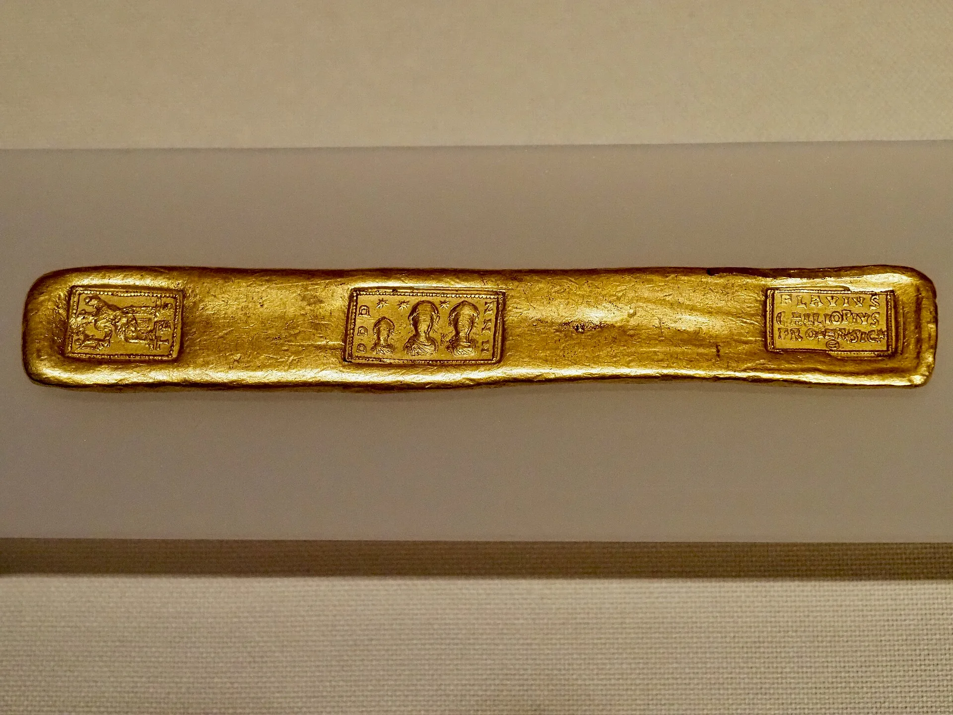 Gold ingot found in Feldioara (Brașov department, Romania), last quarter of the 4th century - early 5th century AD, Bucharest, National Museum of Romanian History (Inv. P. 23169). Photograph taken at the National Archaeological Museum of Madrid during the exhibition Archaeological Treasures of Roman. Physical Gold in a Living Trust: How to Title Bullion for Heirs Without Probate