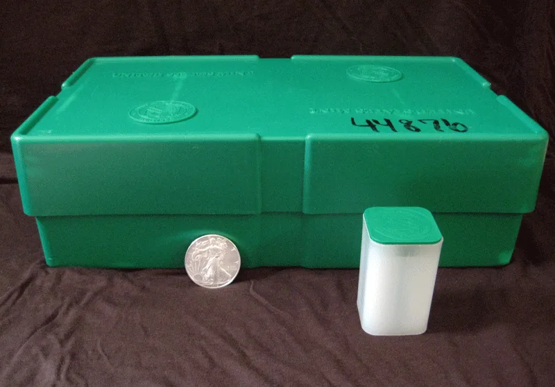 A United States Mint monster box, coin tube, and Silver Eagle